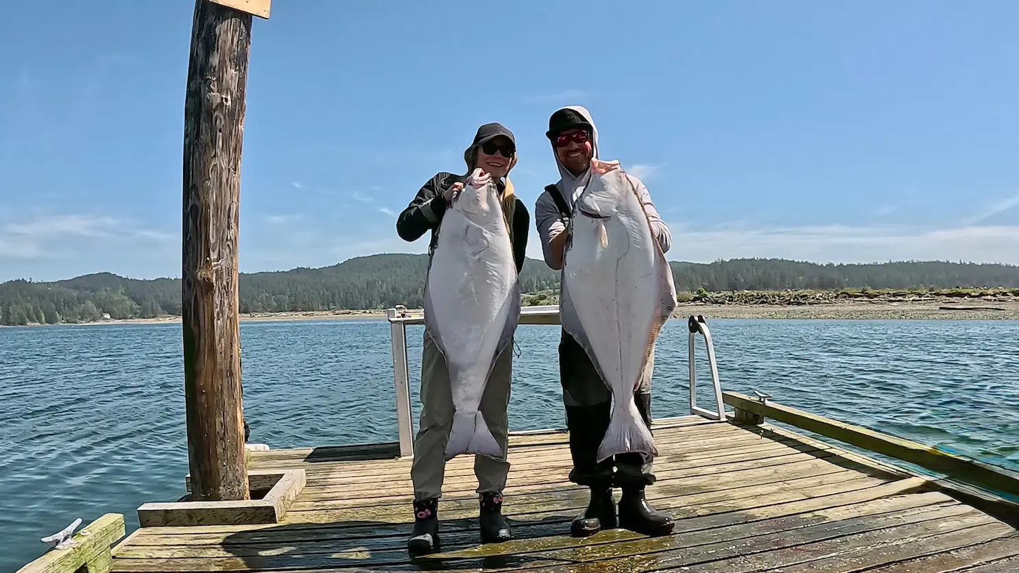 Captain Andrew with guests and their halibut